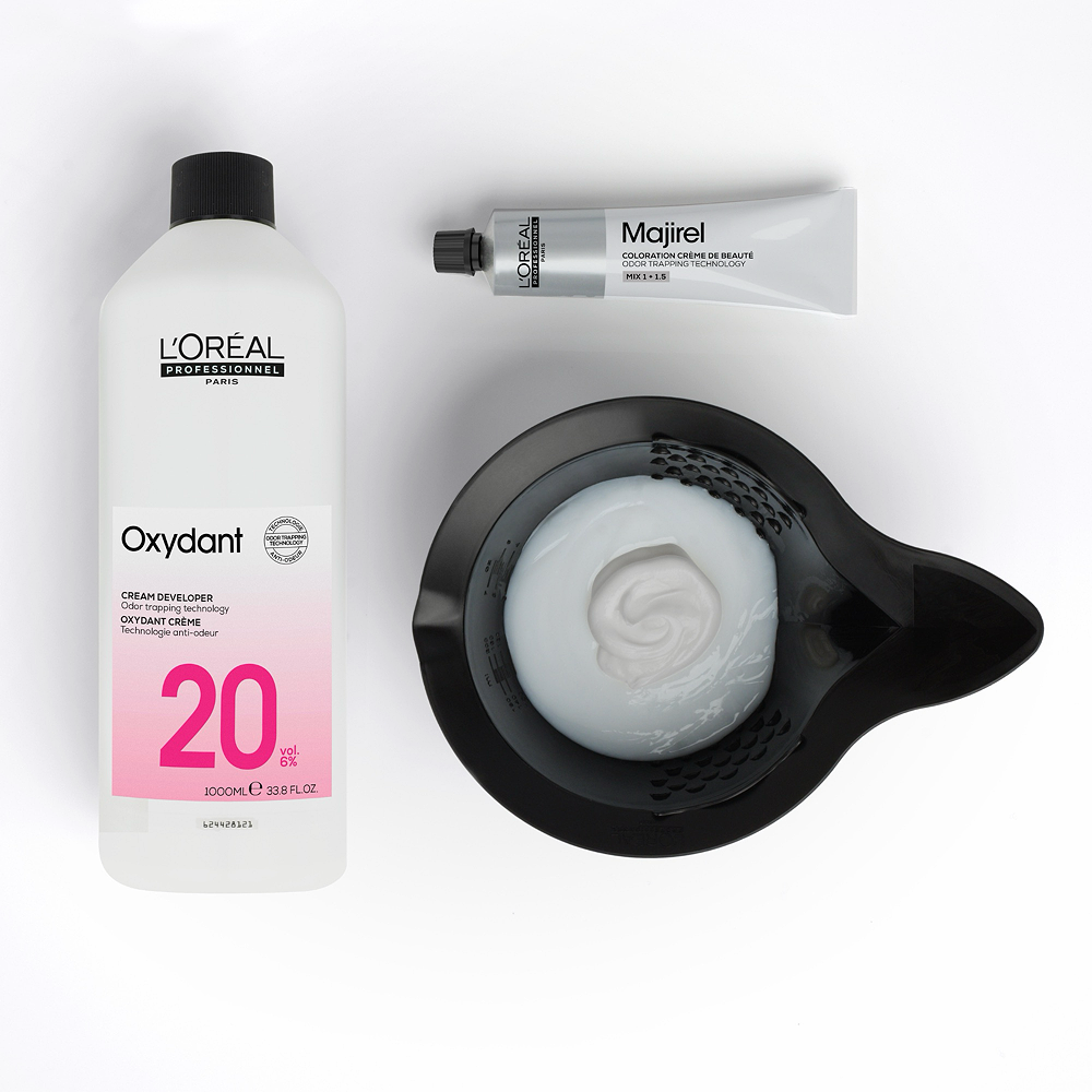 L'Oreal Oxydant cream developer with a bowl of foam on a white background